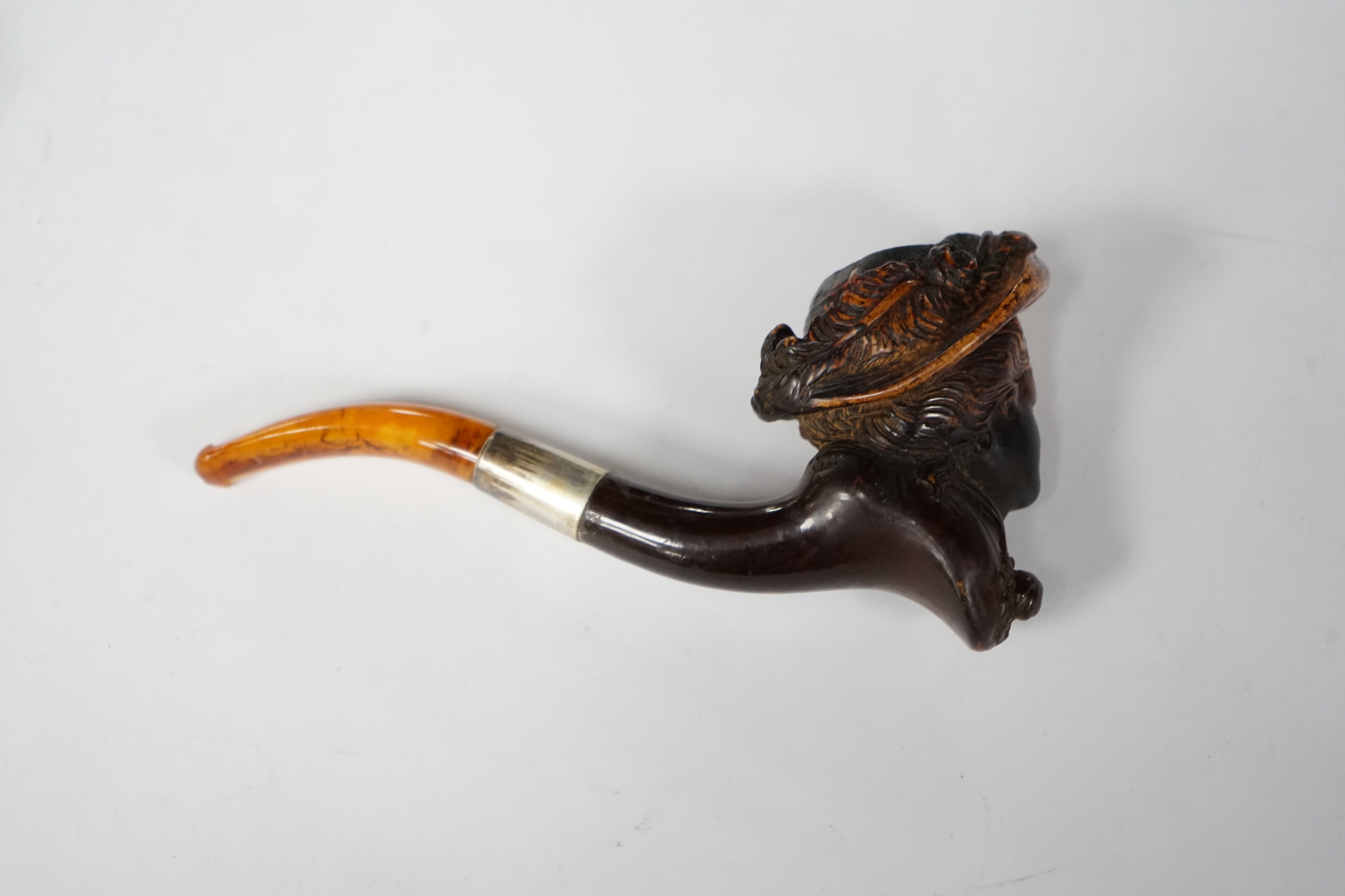 A carved Meerschaum portrait pipe of ‘Mrs Davenport’, late 19th century (see internal note) after a Gainsborough portrait of the lady, with metal mount and amber mouthpiece, 14.5 cm long